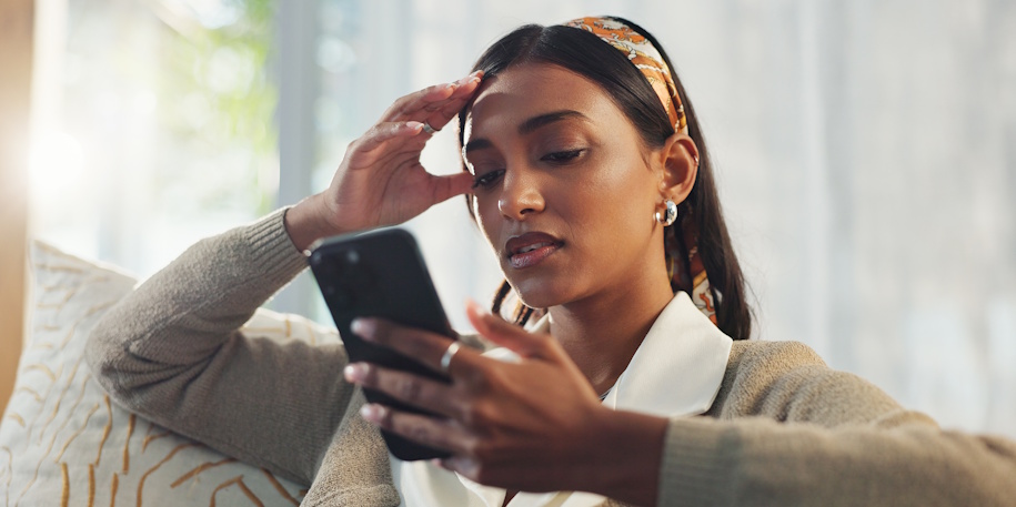 stressed woman looking at phone
